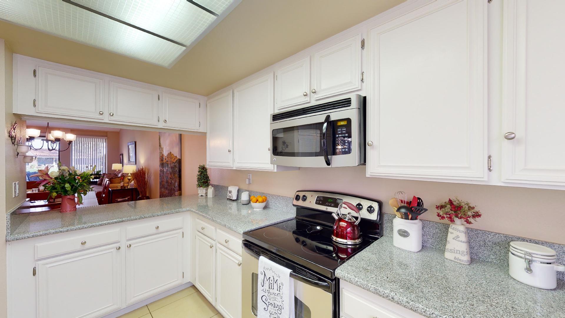 24 Granada Drive Rancho Mirage, CA 92270 - Photo 13 of 36 a kitchen with stainless steel appliances granite countertop a sink a stove and cabinets