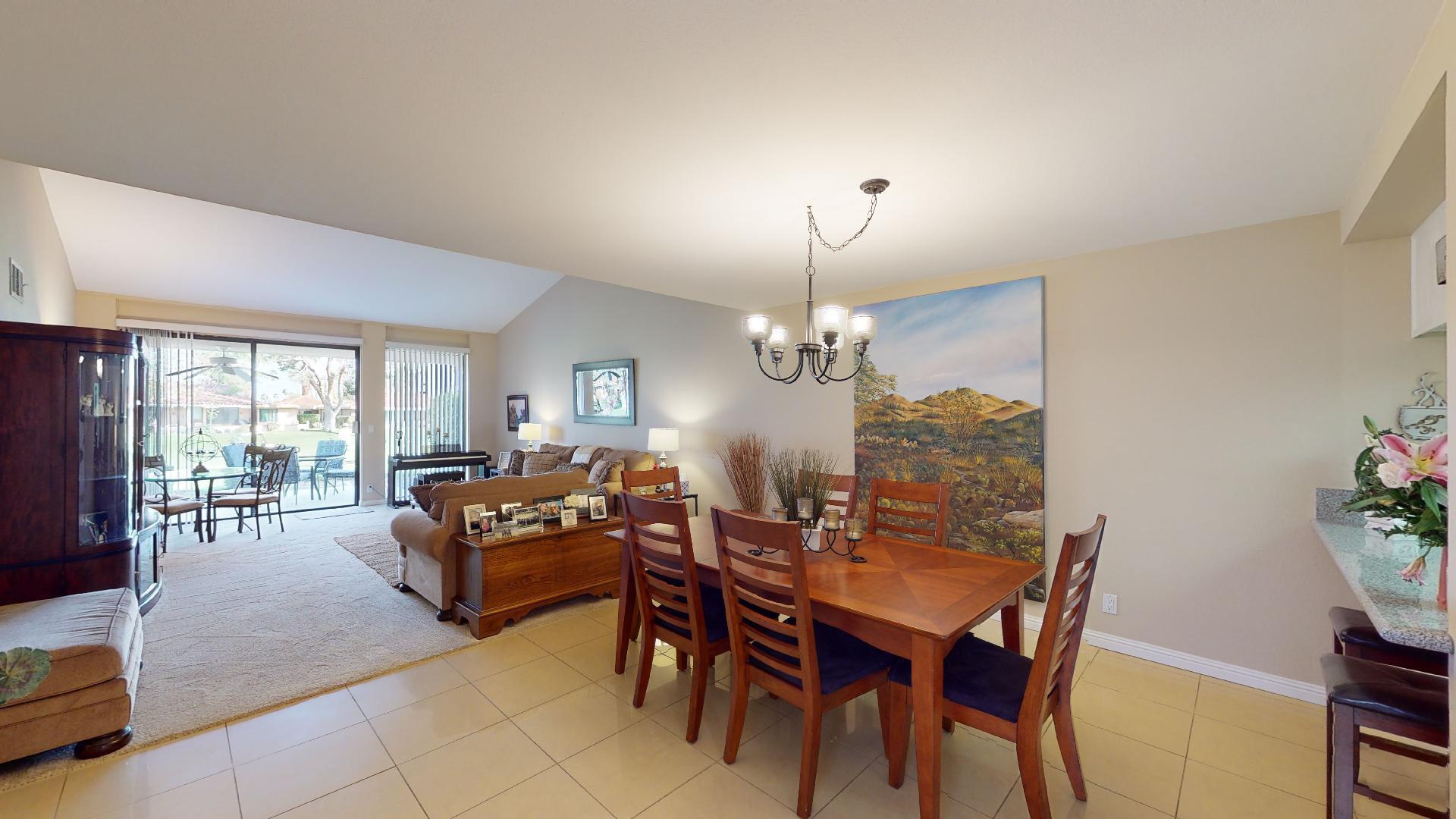 24 Granada Drive Rancho Mirage, CA 92270 - Photo 15 of 36 a view of a dining room with furniture wooden floor and chandelier
