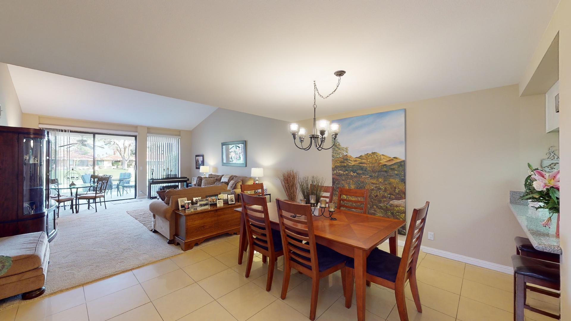 24 Granada Drive Rancho Mirage, CA 92270 - Photo 19 of 36 a view of a dining room with furniture a livingroom and chandelier