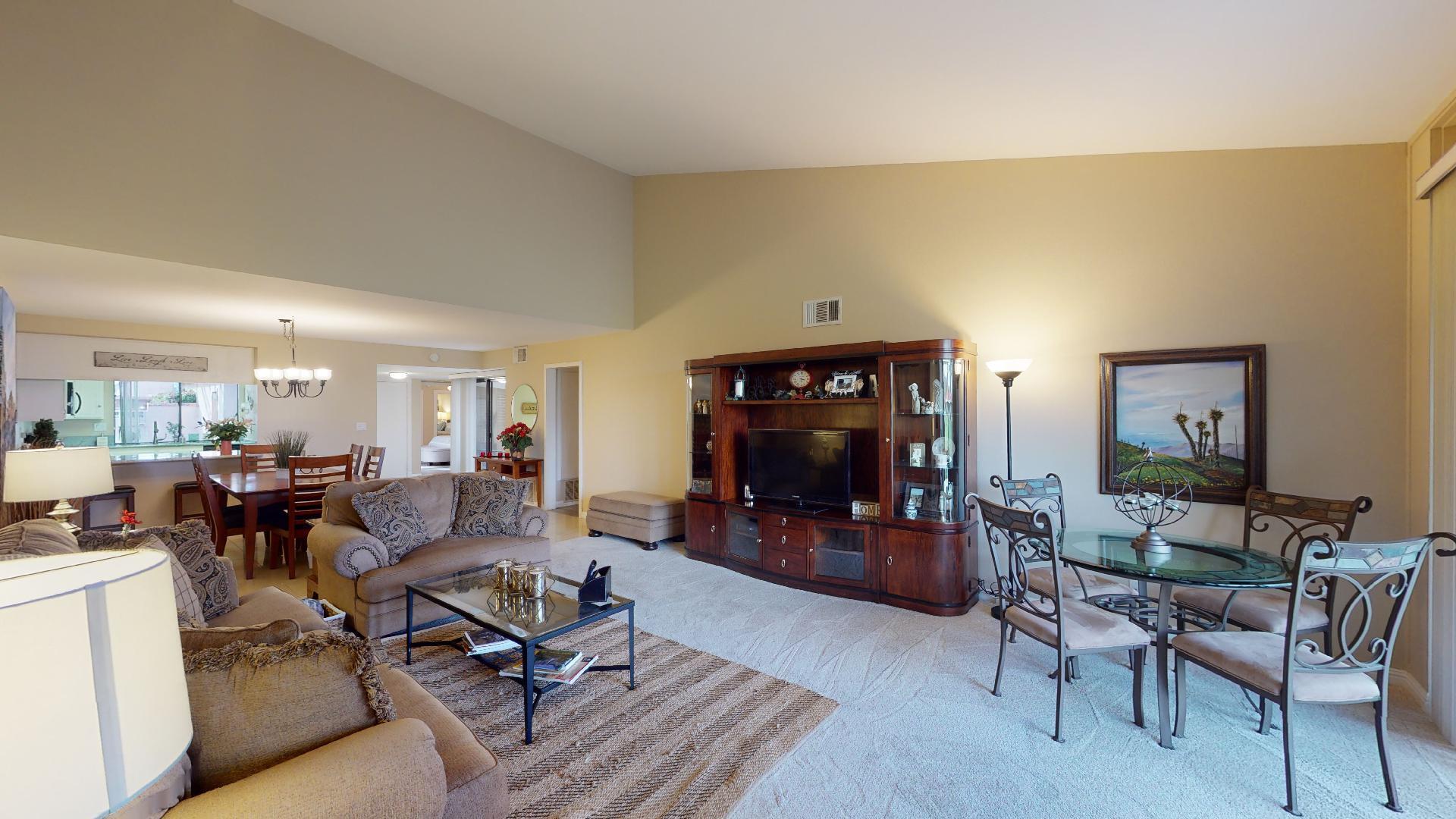 24 Granada Drive Rancho Mirage, CA 92270 - Photo 20 of 36 a living room with furniture a dining table and a fireplace