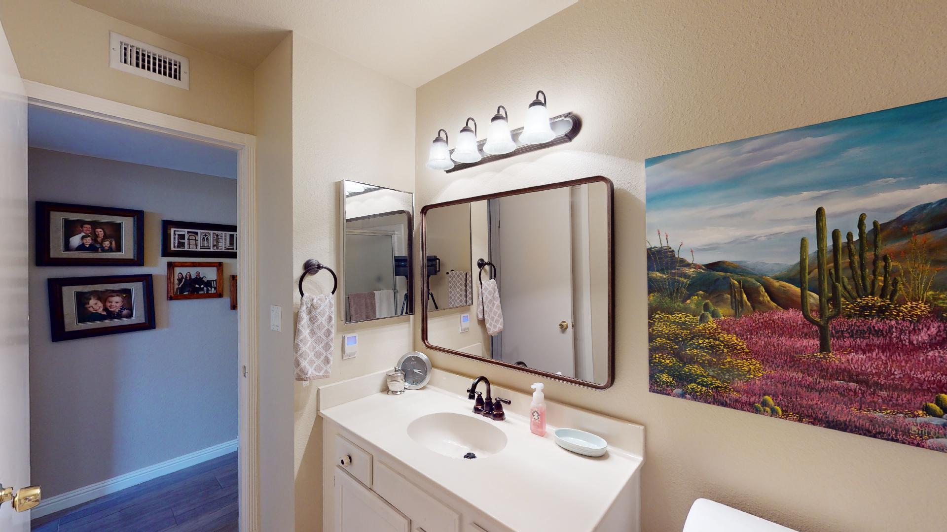24 Granada Drive Rancho Mirage, CA 92270 - Photo 27 of 36 a bathroom with a sink mirror and vanity