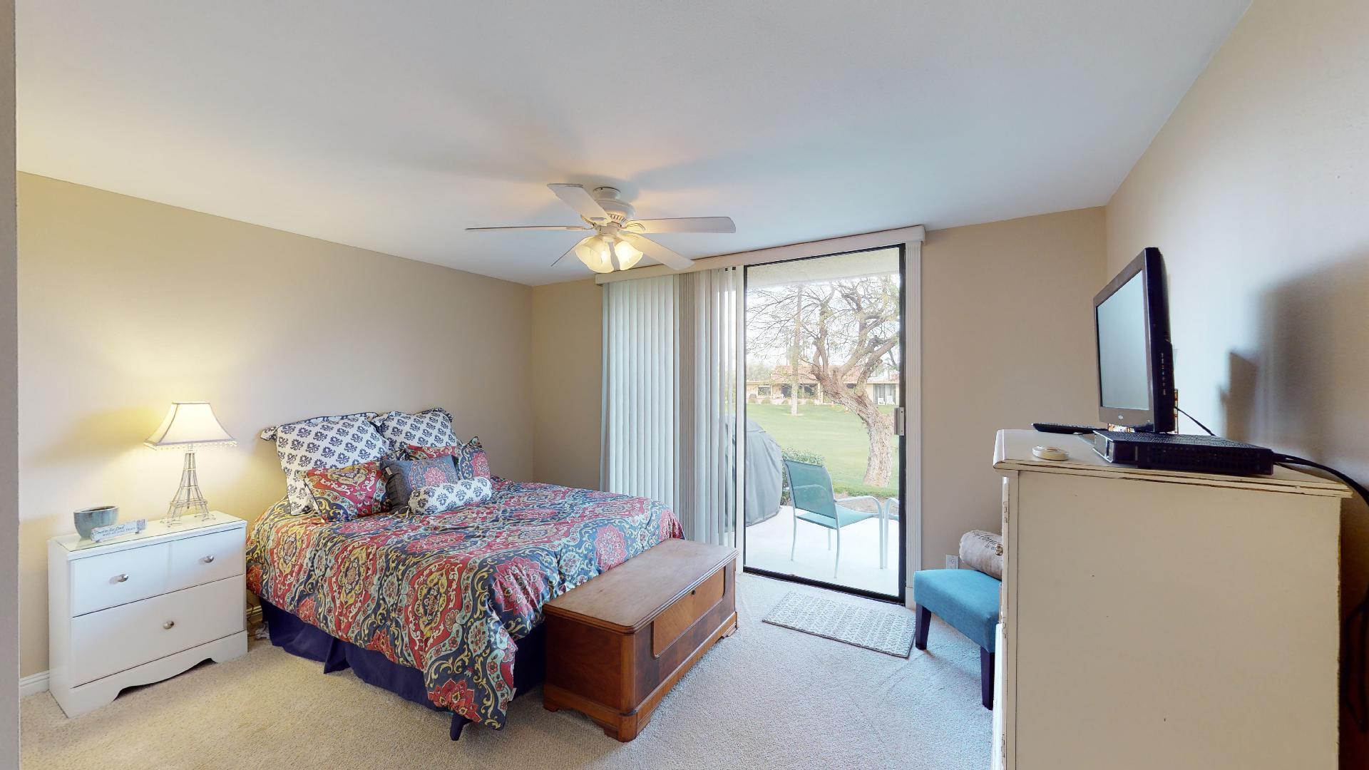 24 Granada Drive Rancho Mirage, CA 92270 - Photo 29 of 36 a spacious bedroom with a bed and a chandelier
