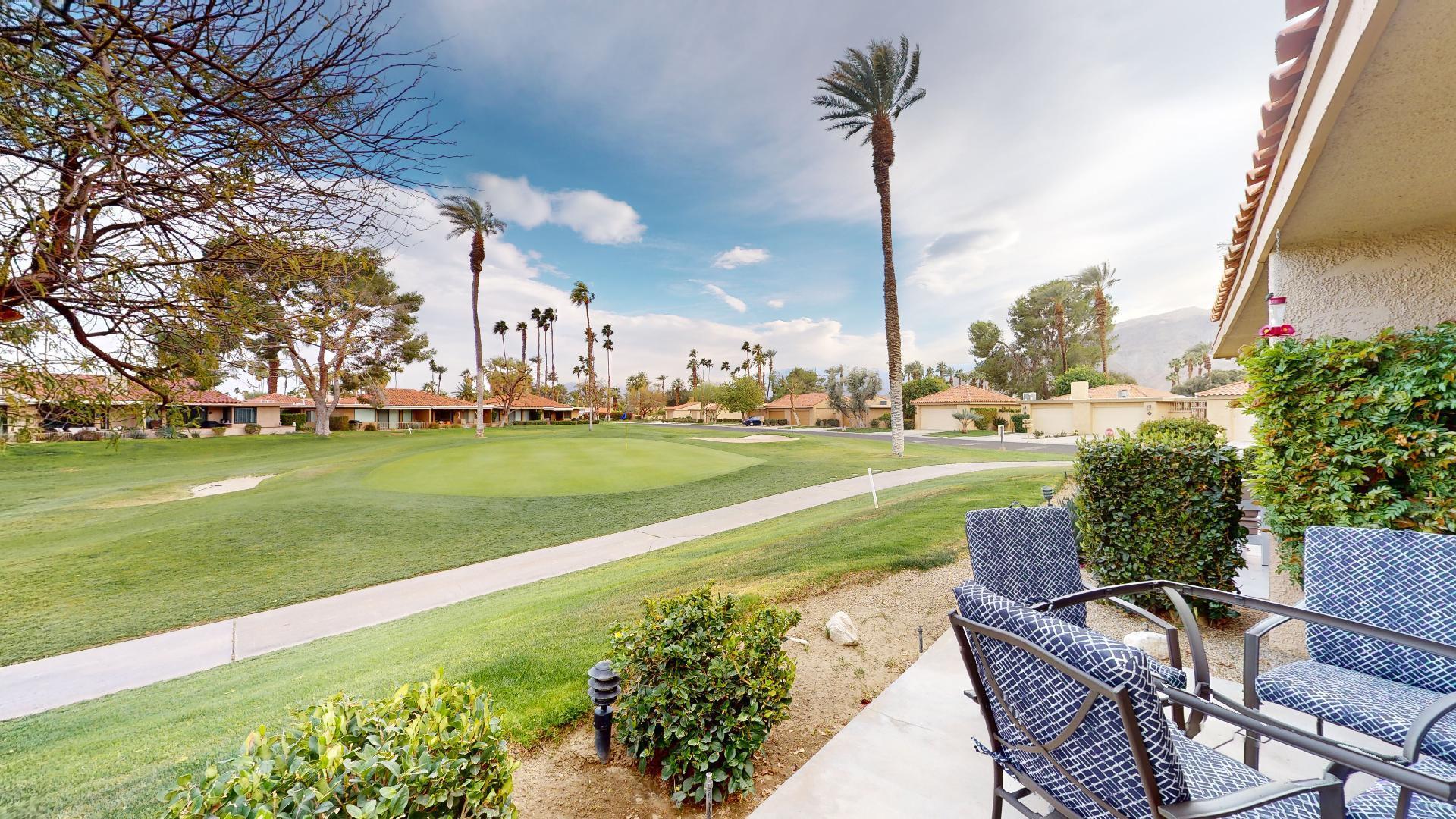 24 Granada Drive Rancho Mirage, CA 92270 - Photo 34 of 36 a view of a fountain in a yard with palm trees