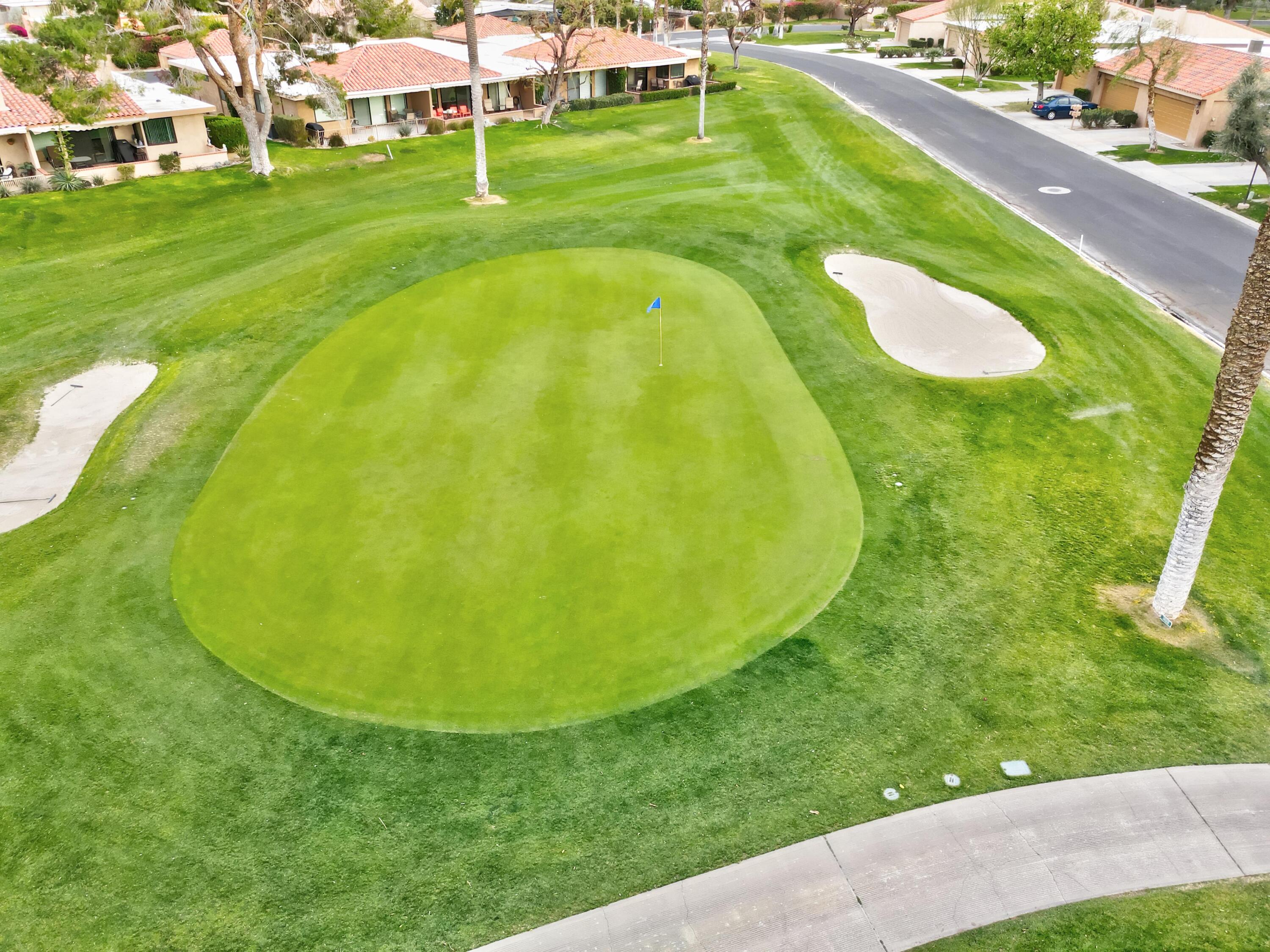 24 Granada Drive Rancho Mirage, CA 92270 - Photo 36 of 36 a view of a swimming pool with a garden and trees