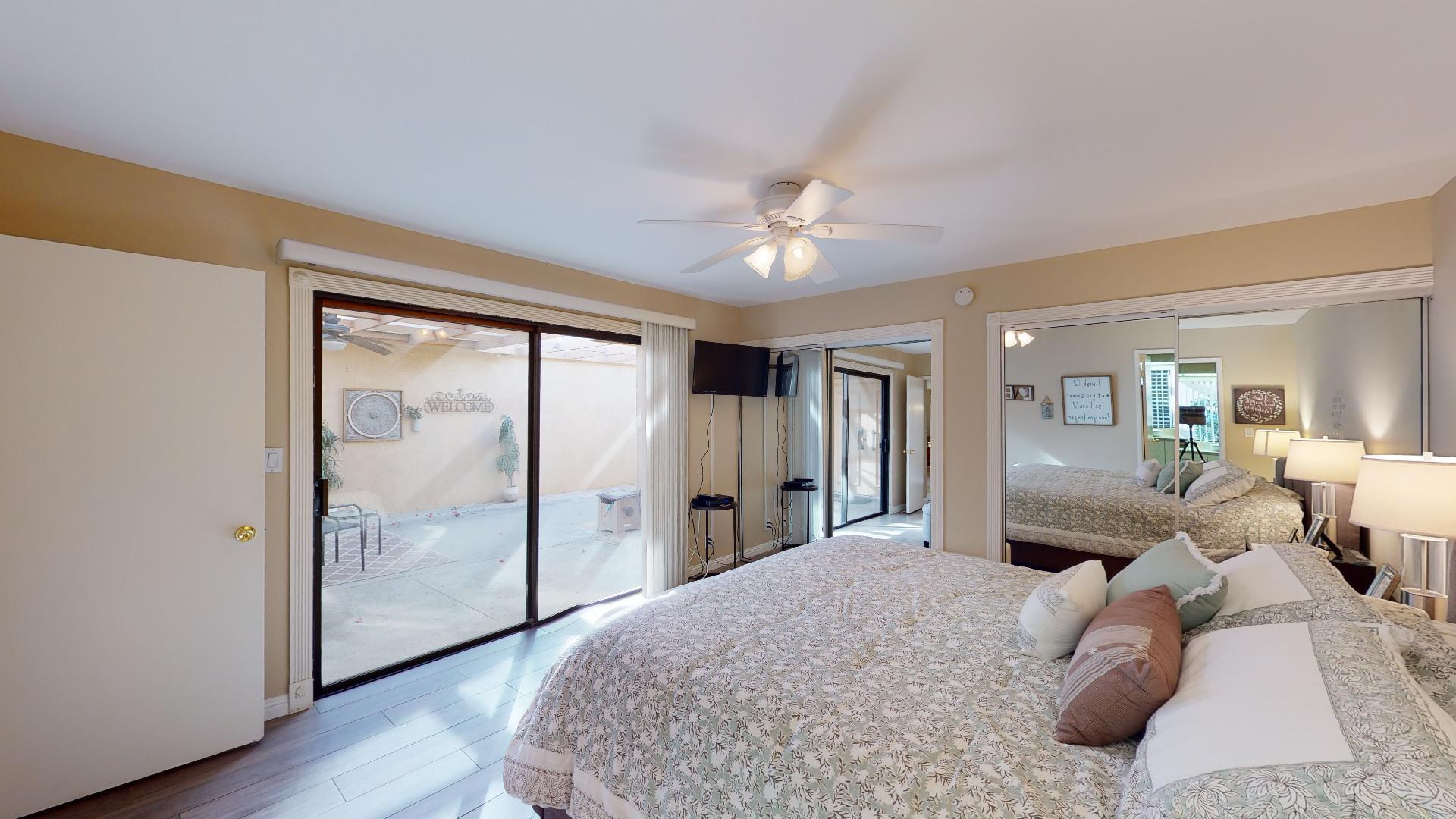 24 Granada Drive Rancho Mirage, CA 92270 - Photo 4 of 36 a spacious bedroom with a large bed and a chandelier