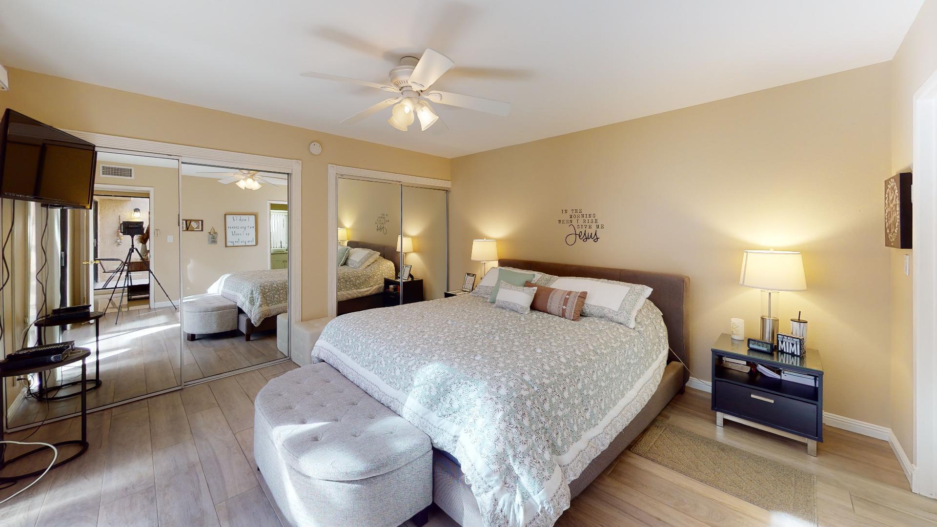 24 Granada Drive Rancho Mirage, CA 92270 - Photo 6 of 36 a bedroom with a large bed and a chandelier