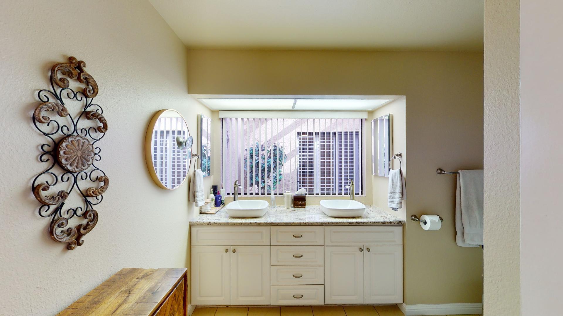 24 Granada Drive Rancho Mirage, CA 92270 - Photo 8 of 36 a bathroom with a sink mirror and window