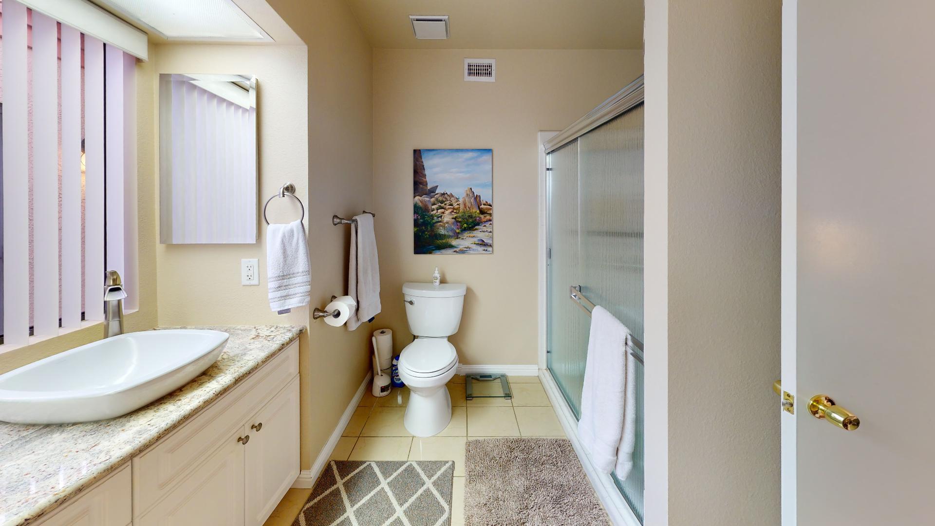 24 Granada Drive Rancho Mirage, CA 92270 - Photo 10 of 36 a bathroom with a granite countertop sink toilet and shower