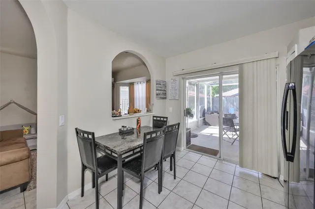 a living room with furniture a flat screen tv and a window