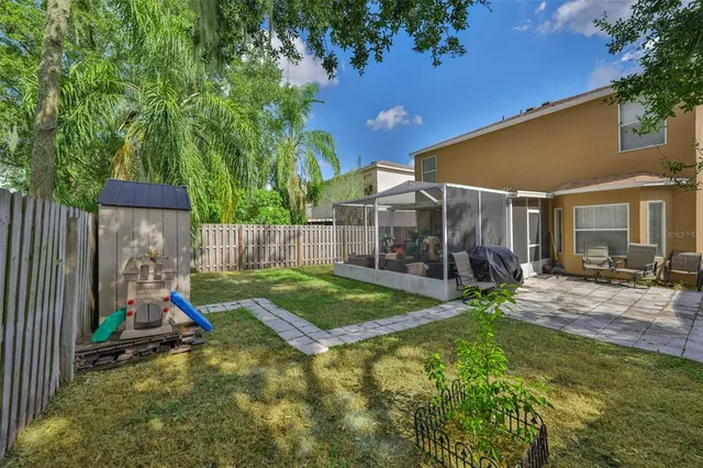 an aerial view of residential houses with outdoor space and trees