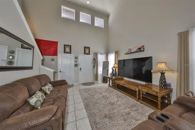 a living room with furniture and a chandelier