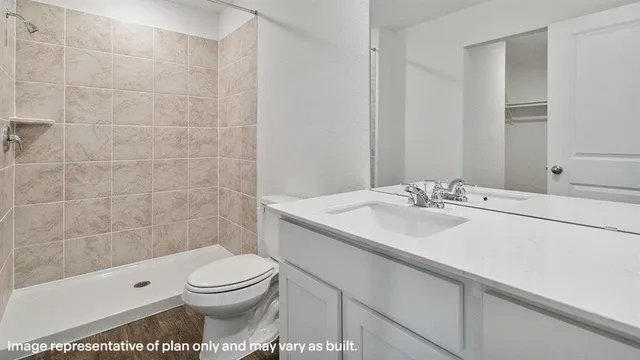 a bathroom with a sink toilet and shower