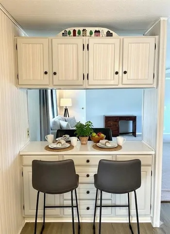 a kitchen with stainless steel appliances kitchen island granite countertop a sink a stove and white cabinets