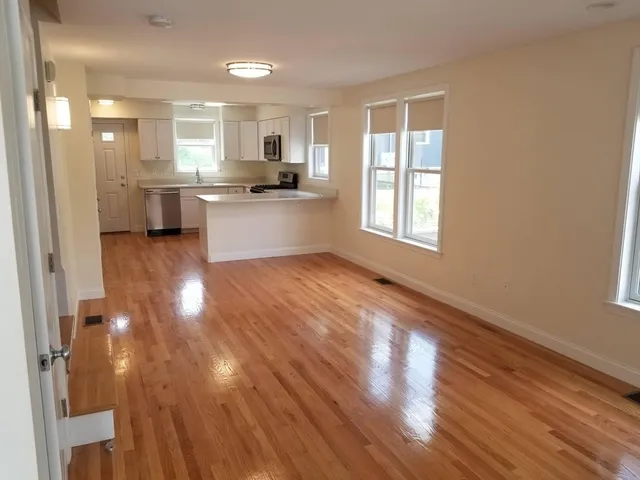 a view of kitchen with wooden floor and electronic appliances