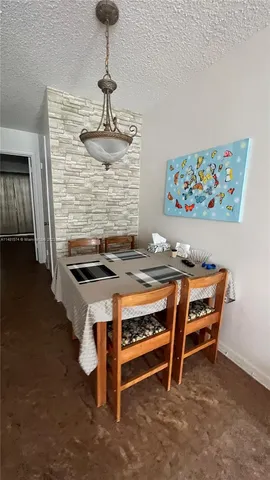 a dining room with a table and chairs