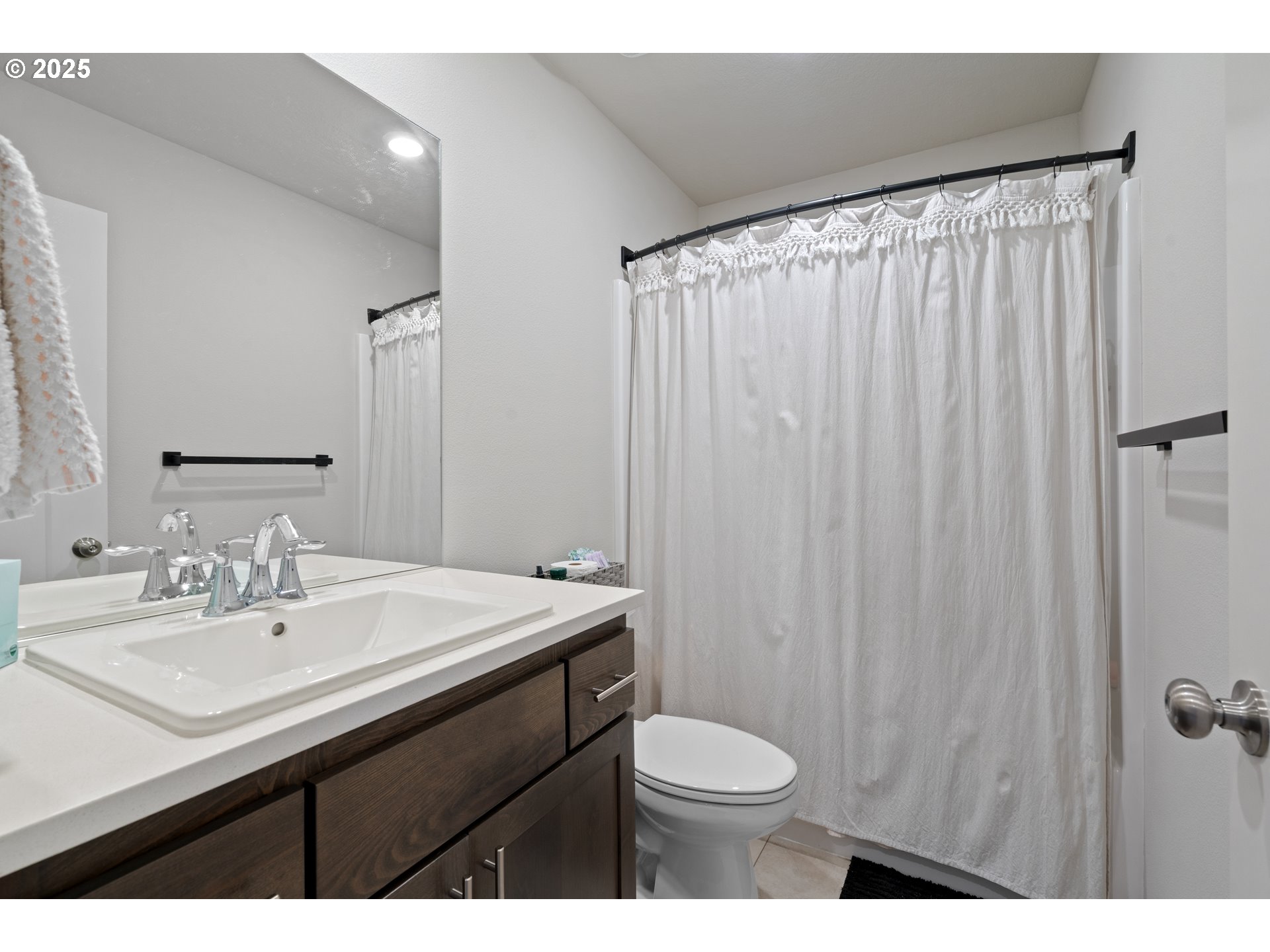 6099 Savannah Street Southeast Albany, OR 97322 - Photo 29 of 32 a bathroom with a sink a toilet a mirror and shower curtain