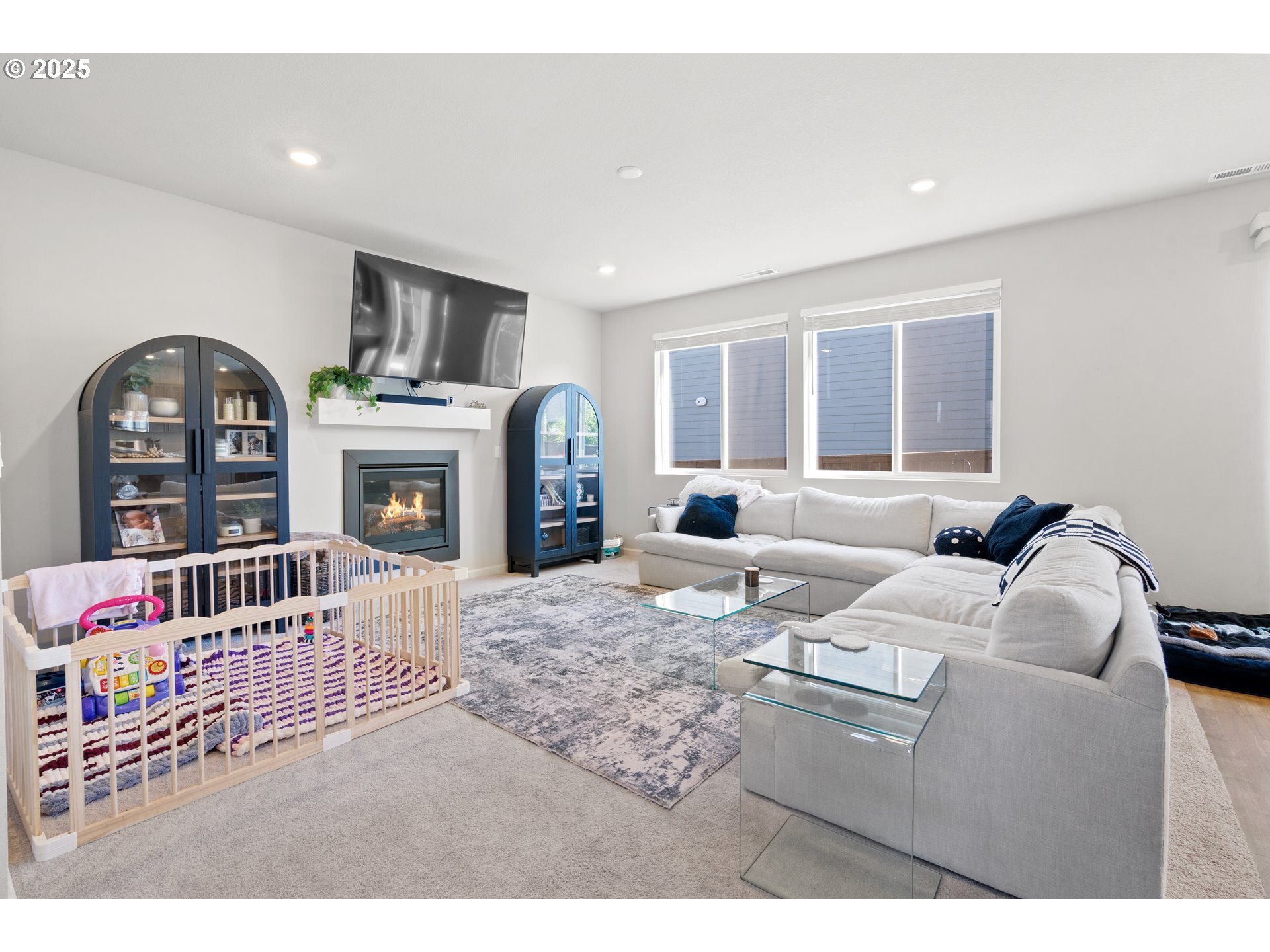 6099 Savannah Street Southeast Albany, OR 97322 - Photo 9 of 32 a living room with furniture a fireplace and a flat screen tv
