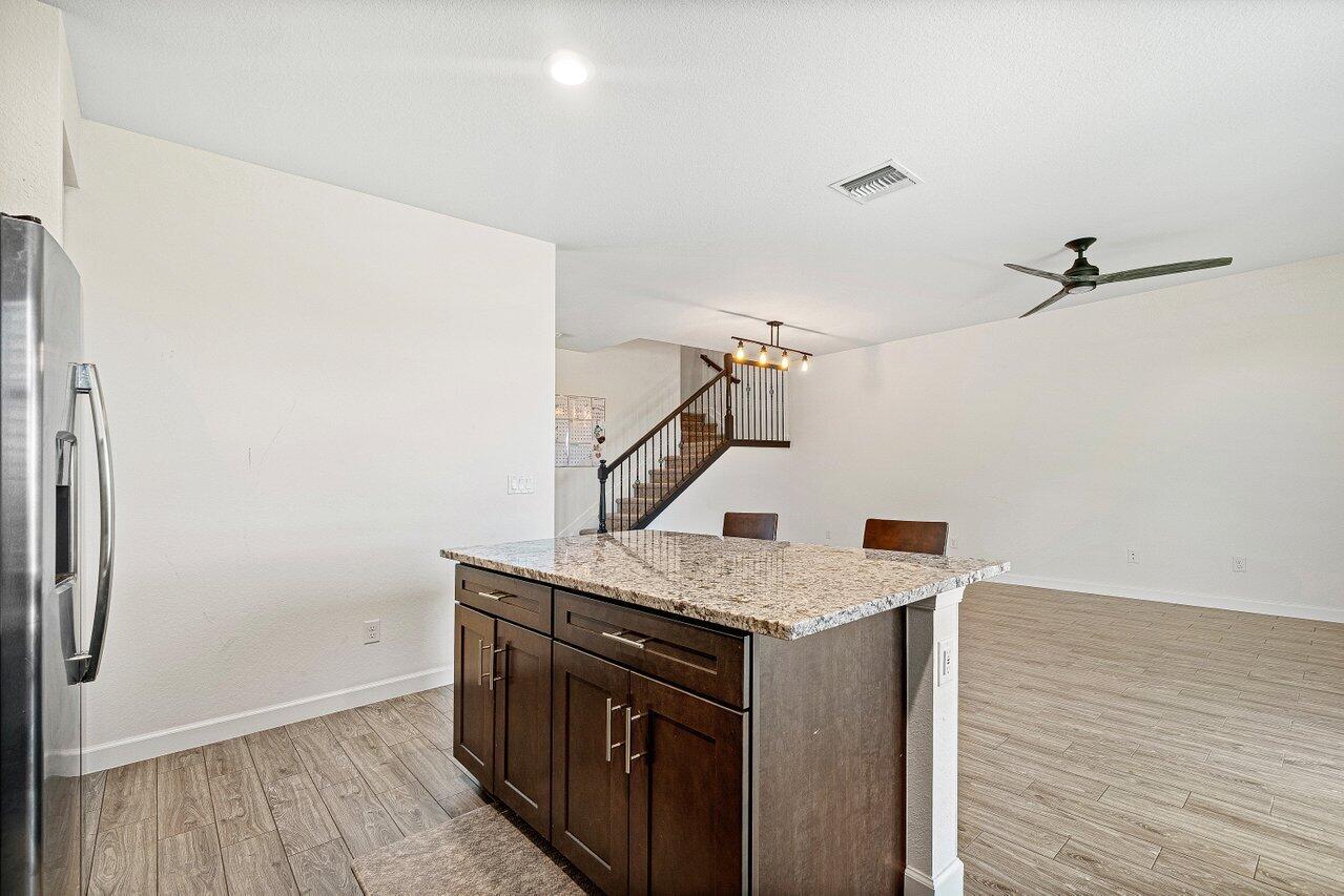 12949 Anthorne Lane Boynton Beach, FL 33436 - Photo 13 of 37 a kitchen with a stove and a refrigerator