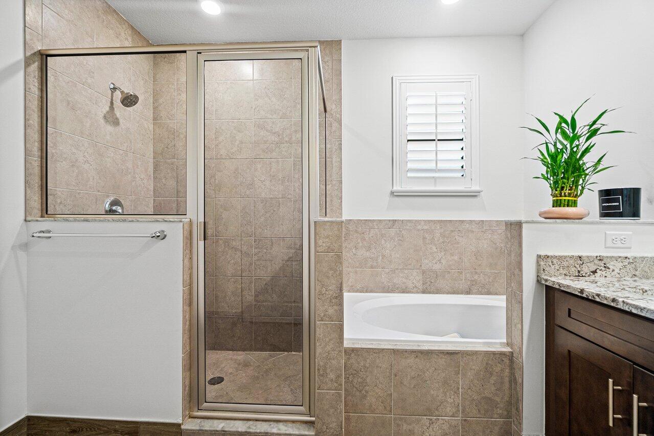12949 Anthorne Lane Boynton Beach, FL 33436 - Photo 18 of 37 a bathroom with a granite countertop sink a potted plant and a shower