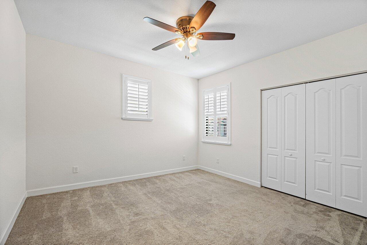 12949 Anthorne Lane Boynton Beach, FL 33436 - Photo 25 of 37 an empty room with windows and fan