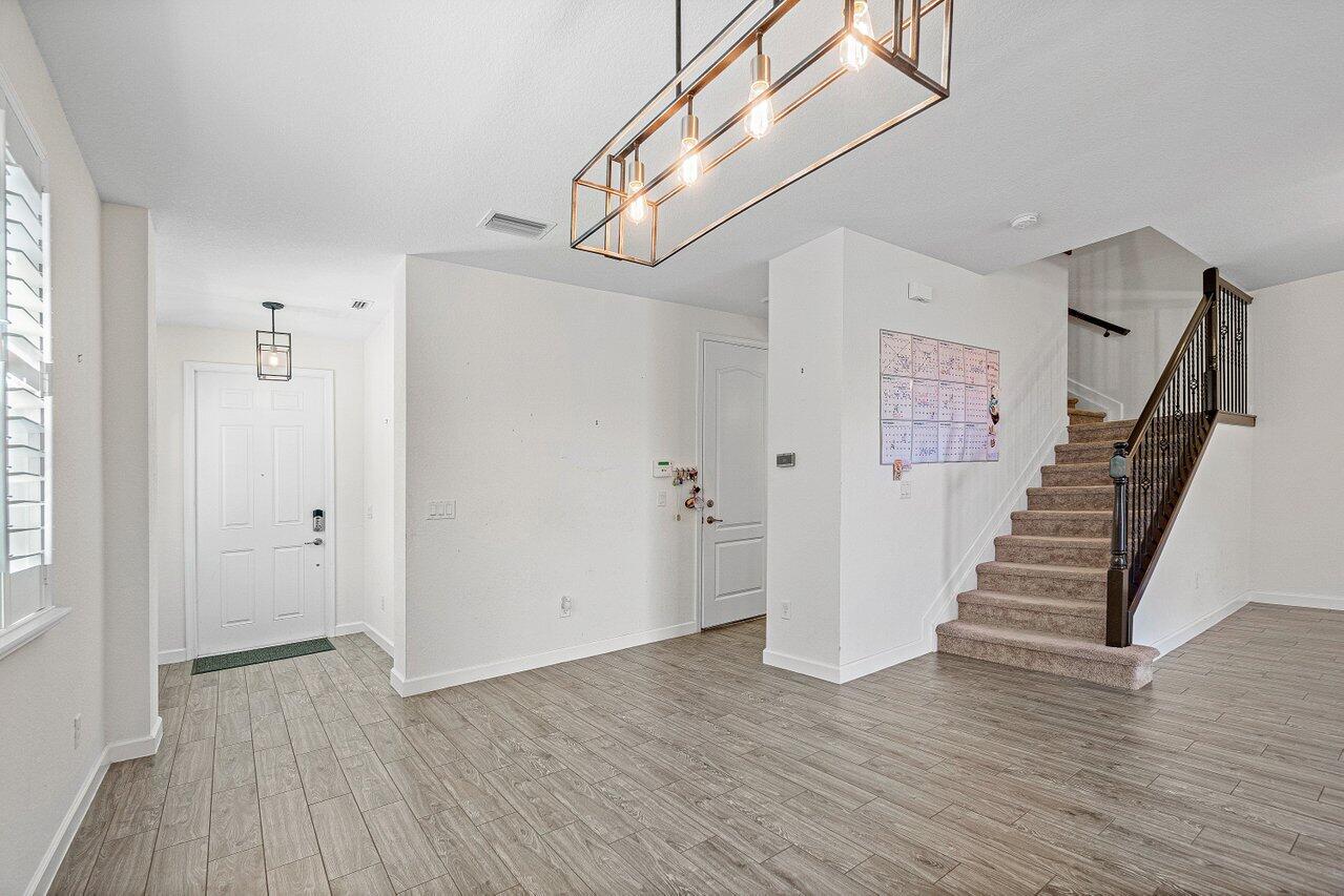 12949 Anthorne Lane Boynton Beach, FL 33436 - Photo 7 of 37 a view of entryway with wooden floor