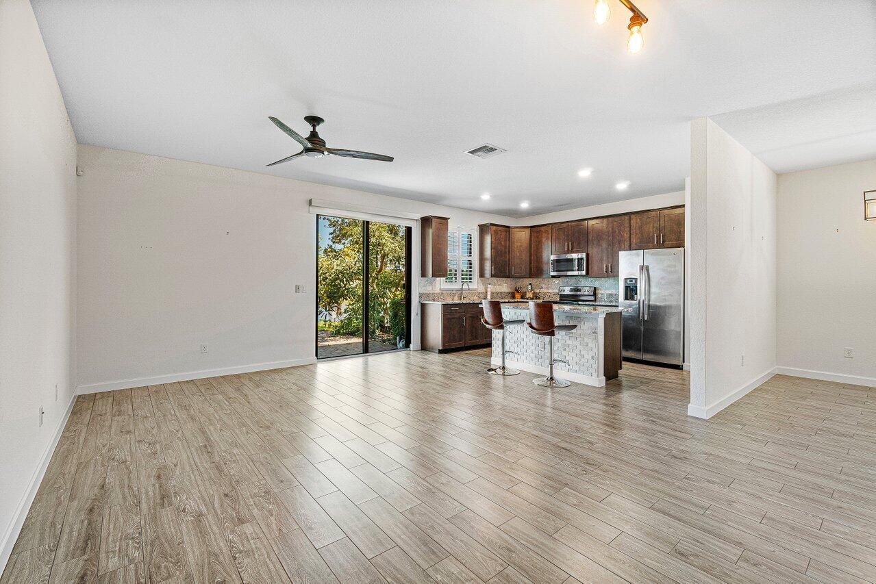 12949 Anthorne Lane Boynton Beach, FL 33436 - Photo 9 of 37 a view of a kitchen with a sink and a refrigerator