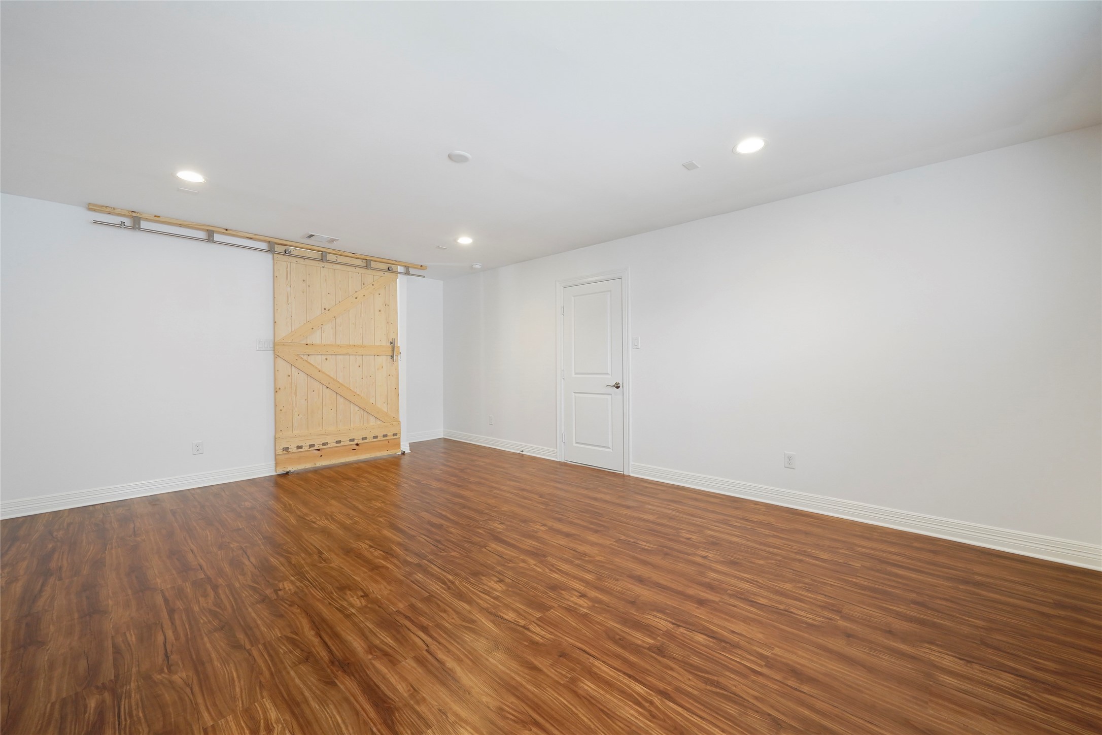 724 Link Road Houston, TX 77009 - Photo 19 of 20 Another view of the great room
on the third floor. Natural wood
barn style door, and attic access
to the right.