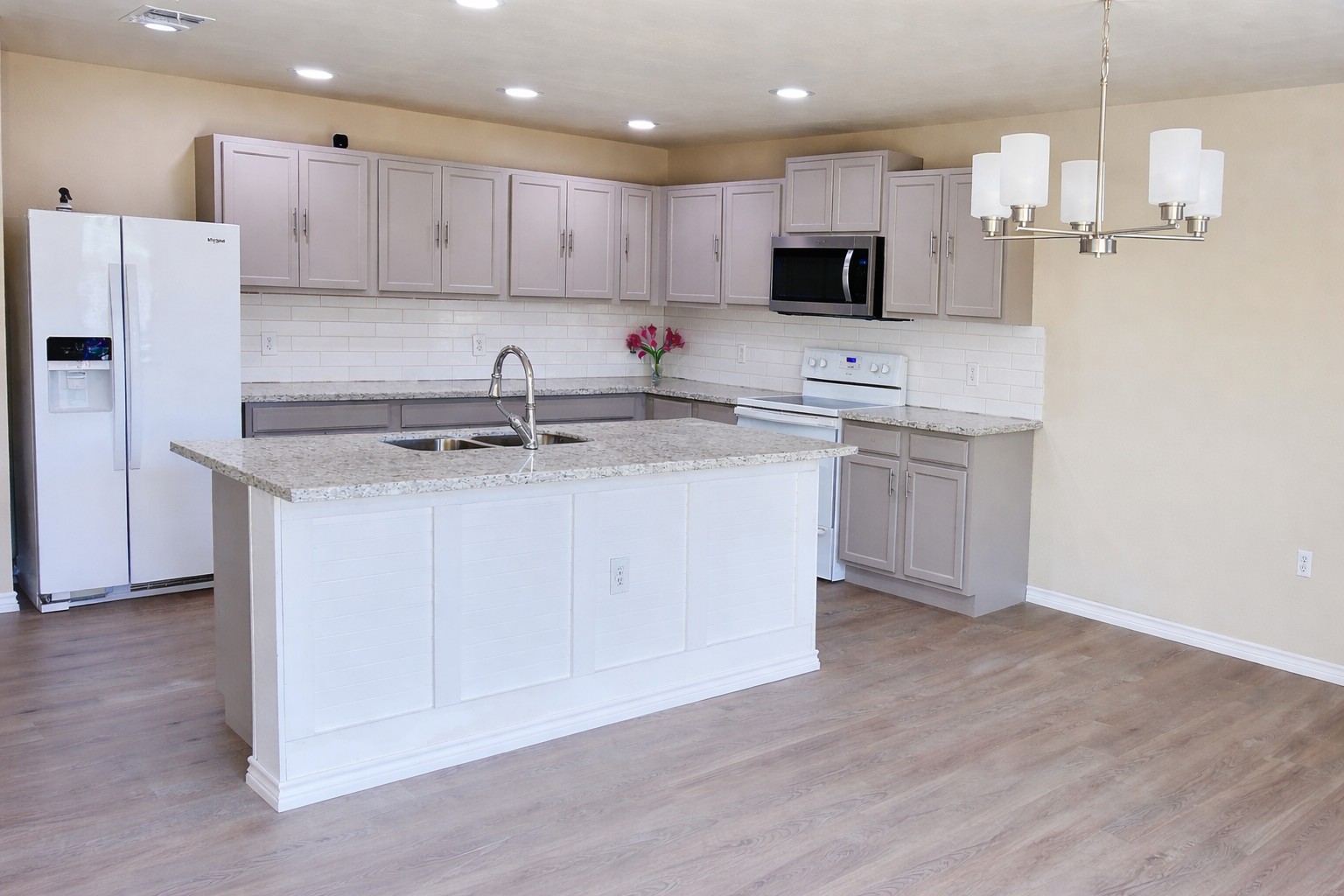 5211 Viewpoint Drive Austin, TX 78744 - Photo 7 of 25 a kitchen with stainless steel appliances granite countertop a sink a stove a refrigerator and white cabinets