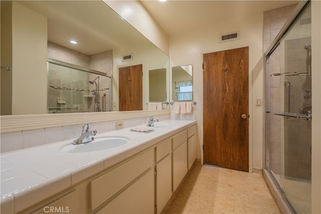 920 South Spring Meadow Drive West Covina, CA 91791 - Photo 19 of 48 a bathroom with a double vanity sink and mirror
