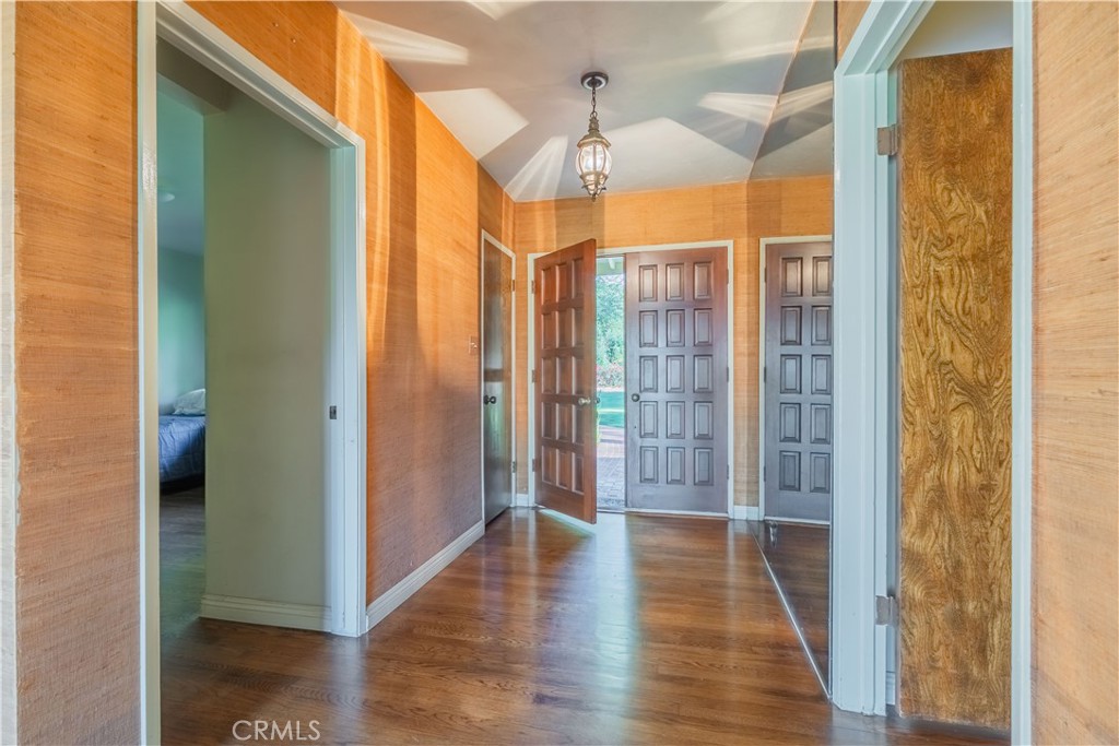 920 South Spring Meadow Drive West Covina, CA 91791 - Photo 7 of 48 a view of a hallway with wooden floor and chandelier