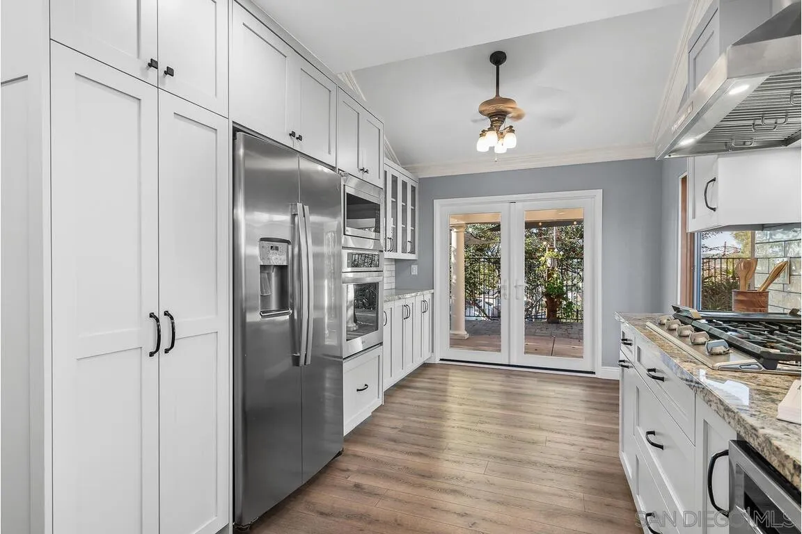 9160 Paseo Cresta Santee, CA 92071 - Photo 12 of 42 a kitchen with stainless steel appliances a refrigerator and a stove