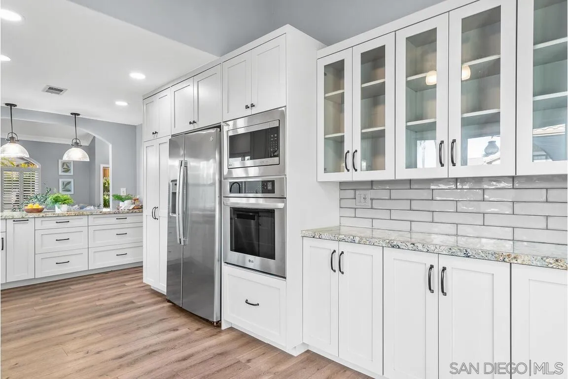 9160 Paseo Cresta Santee, CA 92071 - Photo 13 of 42 a kitchen with granite countertop cabinets and stainless steel appliances