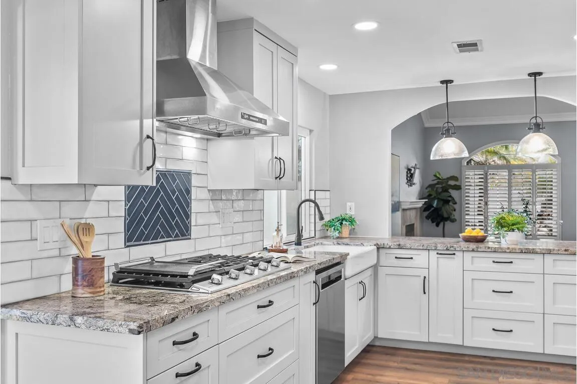 9160 Paseo Cresta Santee, CA 92071 - Photo 15 of 42 a kitchen with white cabinets and appliances