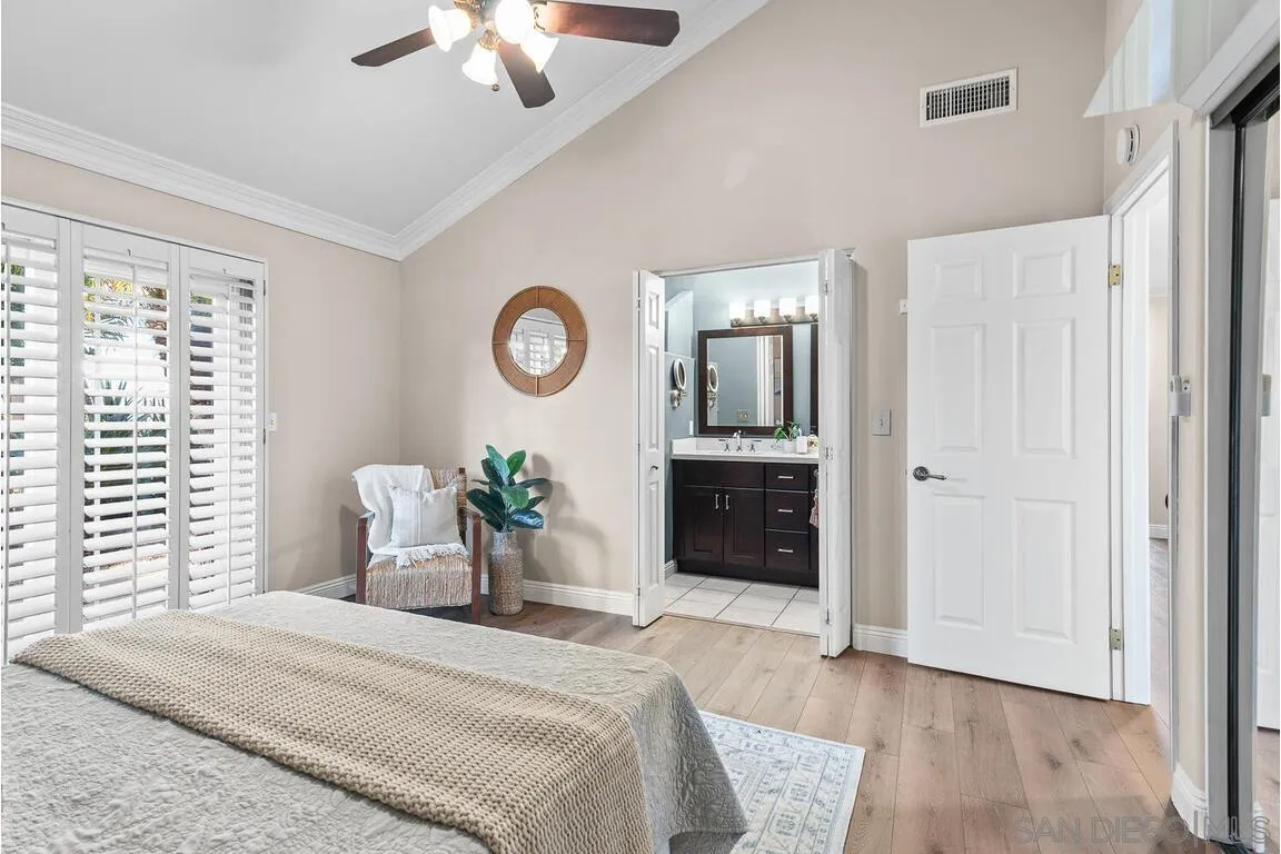 9160 Paseo Cresta Santee, CA 92071 - Photo 17 of 42 a bedroom with a bed and a chandelier
