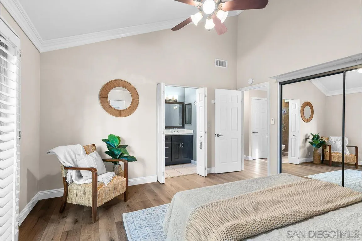 9160 Paseo Cresta Santee, CA 92071 - Photo 18 of 42 a bedroom with bed and a chandelier