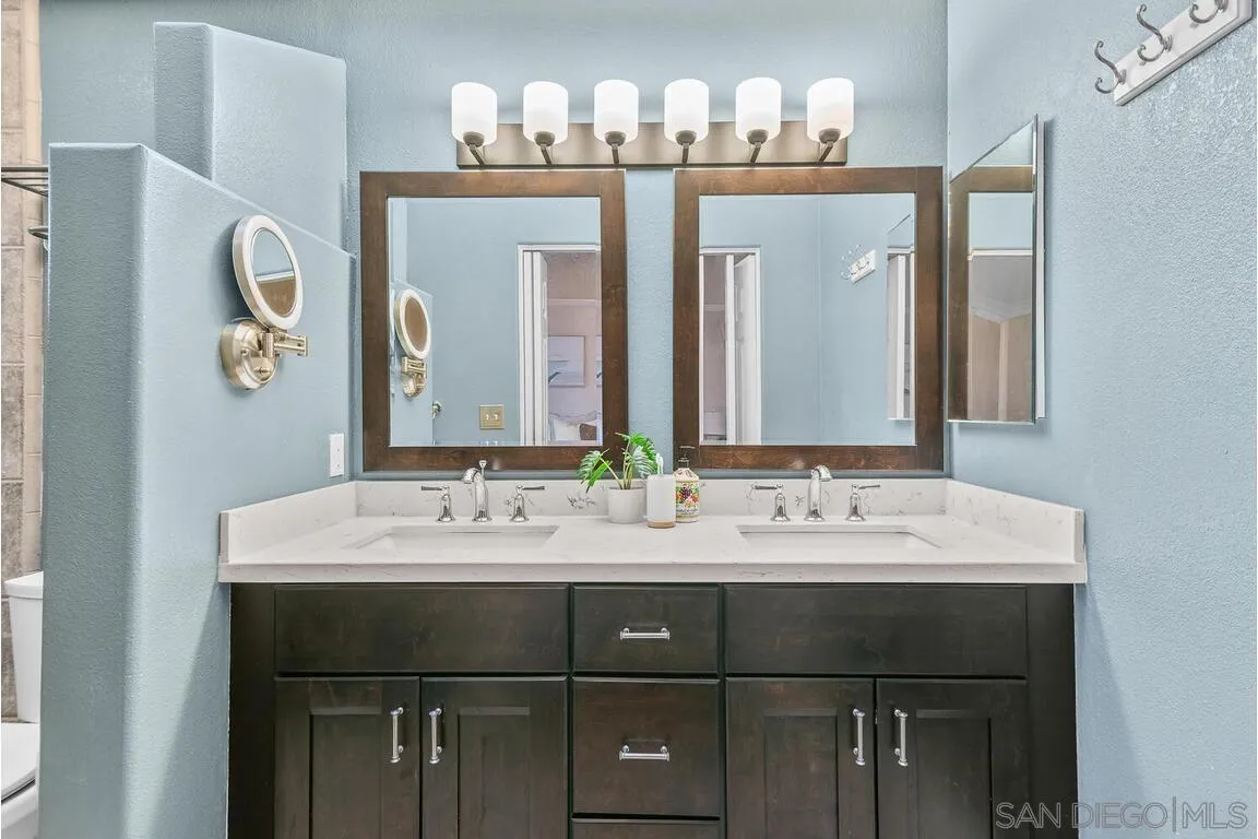 9160 Paseo Cresta Santee, CA 92071 - Photo 19 of 42 a bathroom with a double vanity sink and a mirror