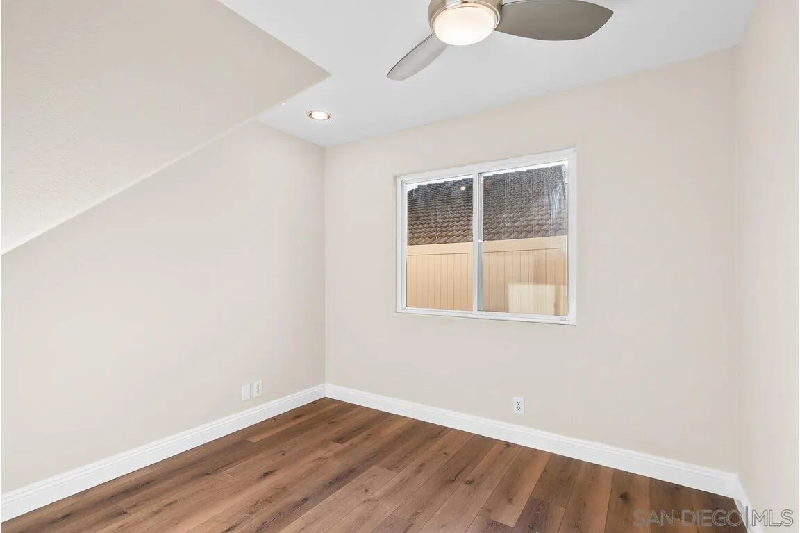 9160 Paseo Cresta Santee, CA 92071 - Photo 21 of 42 a view of an empty room with wooden floor and a window