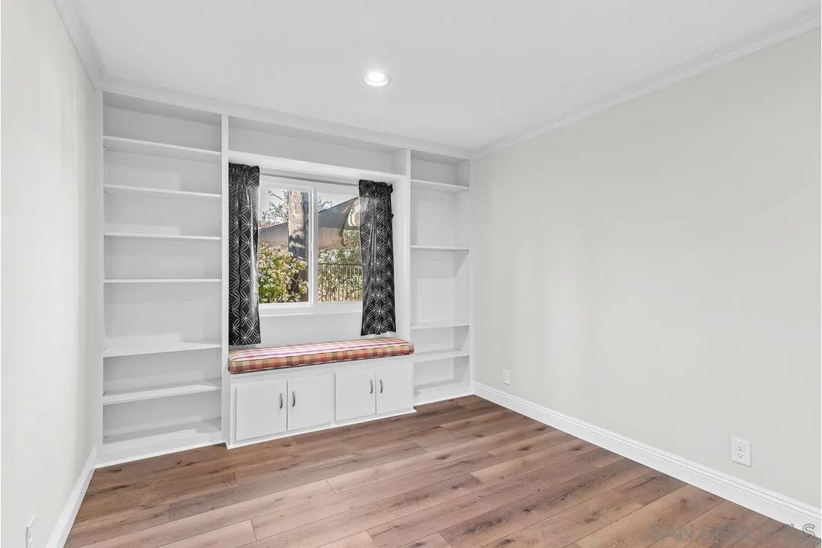 9160 Paseo Cresta Santee, CA 92071 - Photo 23 of 42 a view of an empty room with a window and wooden floor