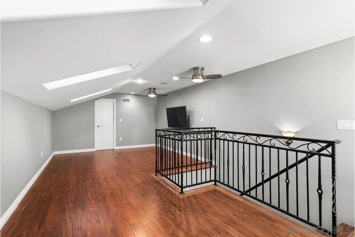 9160 Paseo Cresta Santee, CA 92071 - Photo 24 of 42 a view of a hallway with wooden floor