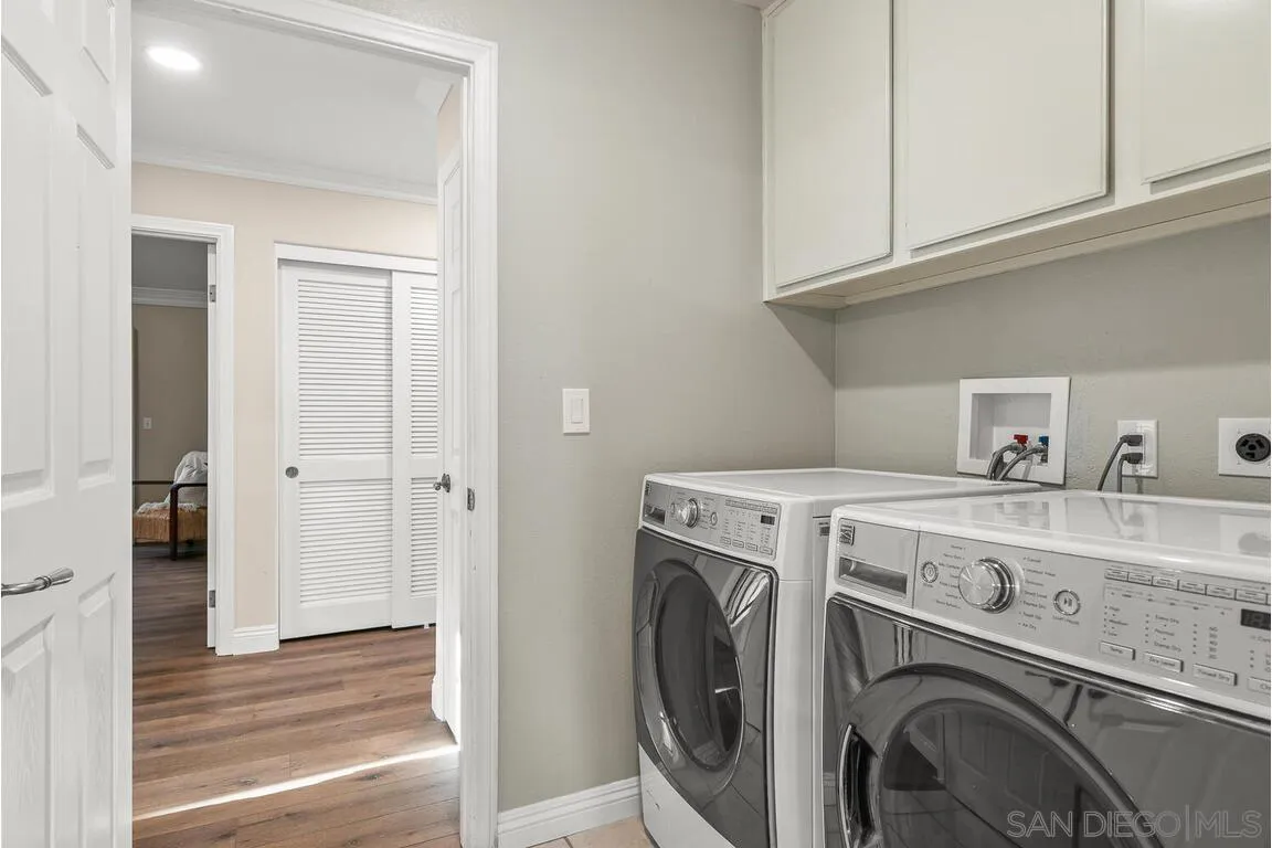 9160 Paseo Cresta Santee, CA 92071 - Photo 28 of 42 a view of washer and dryer with kitchen in the background