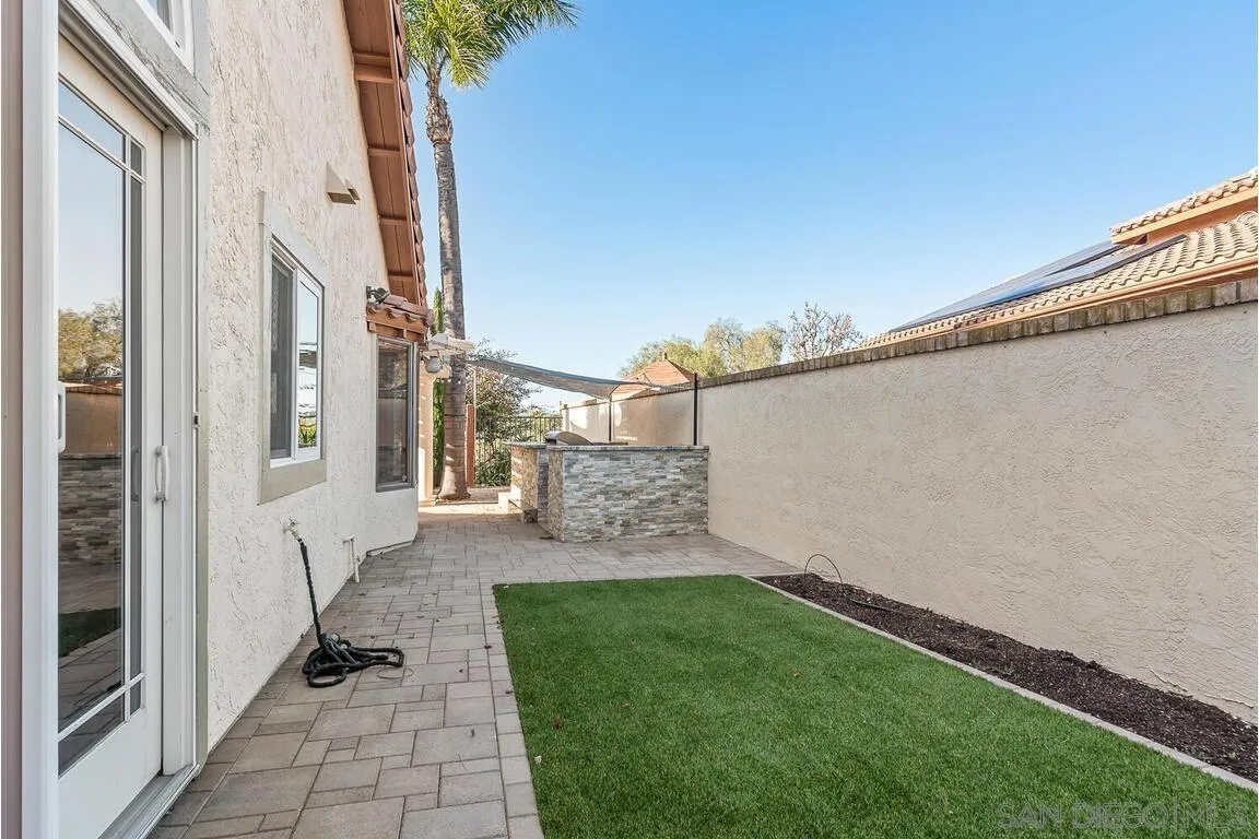 9160 Paseo Cresta Santee, CA 92071 - Photo 30 of 42 a view of a patio with table and chairs and wooden fence