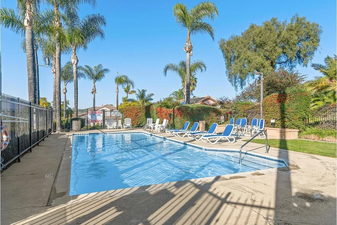 9160 Paseo Cresta Santee, CA 92071 - Photo 40 of 42 a view of a swimming pool with a lounge chairs