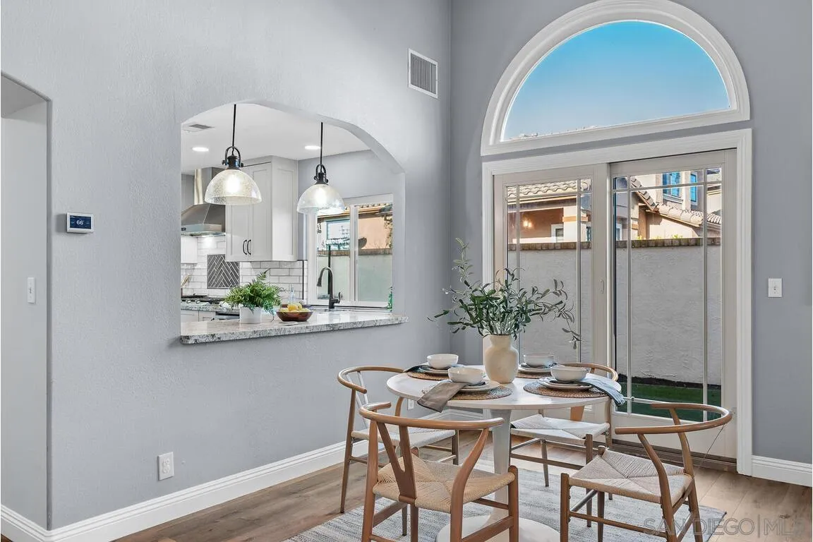 9160 Paseo Cresta Santee, CA 92071 - Photo 8 of 42 a view of a dining room with furniture window and wooden floor