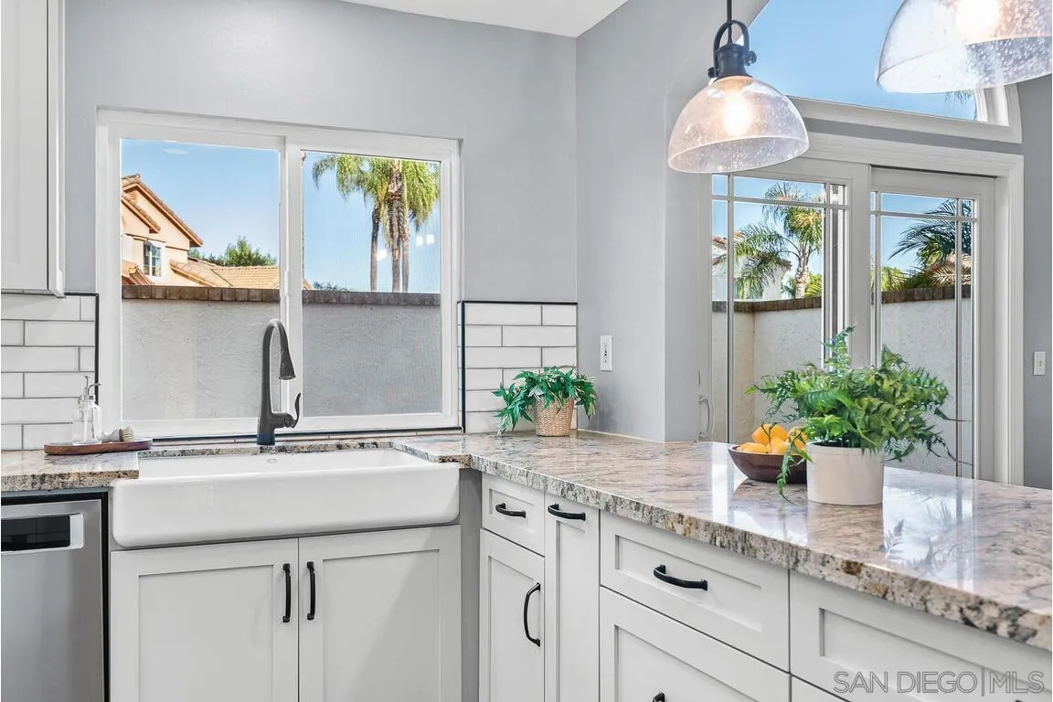 9160 Paseo Cresta Santee, CA 92071 - Photo 10 of 42 a kitchen with a sink a window and cabinets