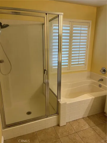 a bathroom with a granite countertop sink a mirror and bathtub
