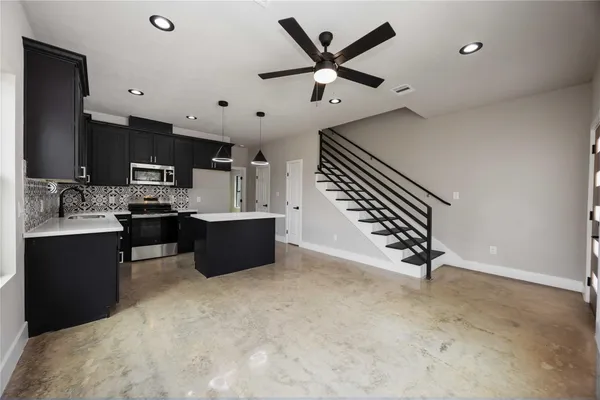a kitchen with a sink stainless steel appliances and counter space