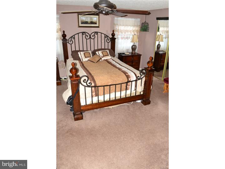 12023 Tyrone Road Philadelphia, PA 19154 - Photo 11 of 16 a view of a bedroom with a bed and table