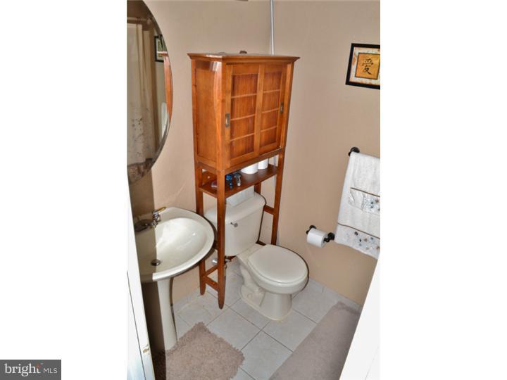 12023 Tyrone Road Philadelphia, PA 19154 - Photo 9 of 16 a bathroom with a sink toilet and mirror