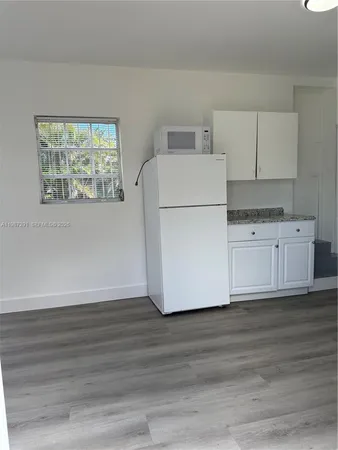 a view of cabinets and wooden floor