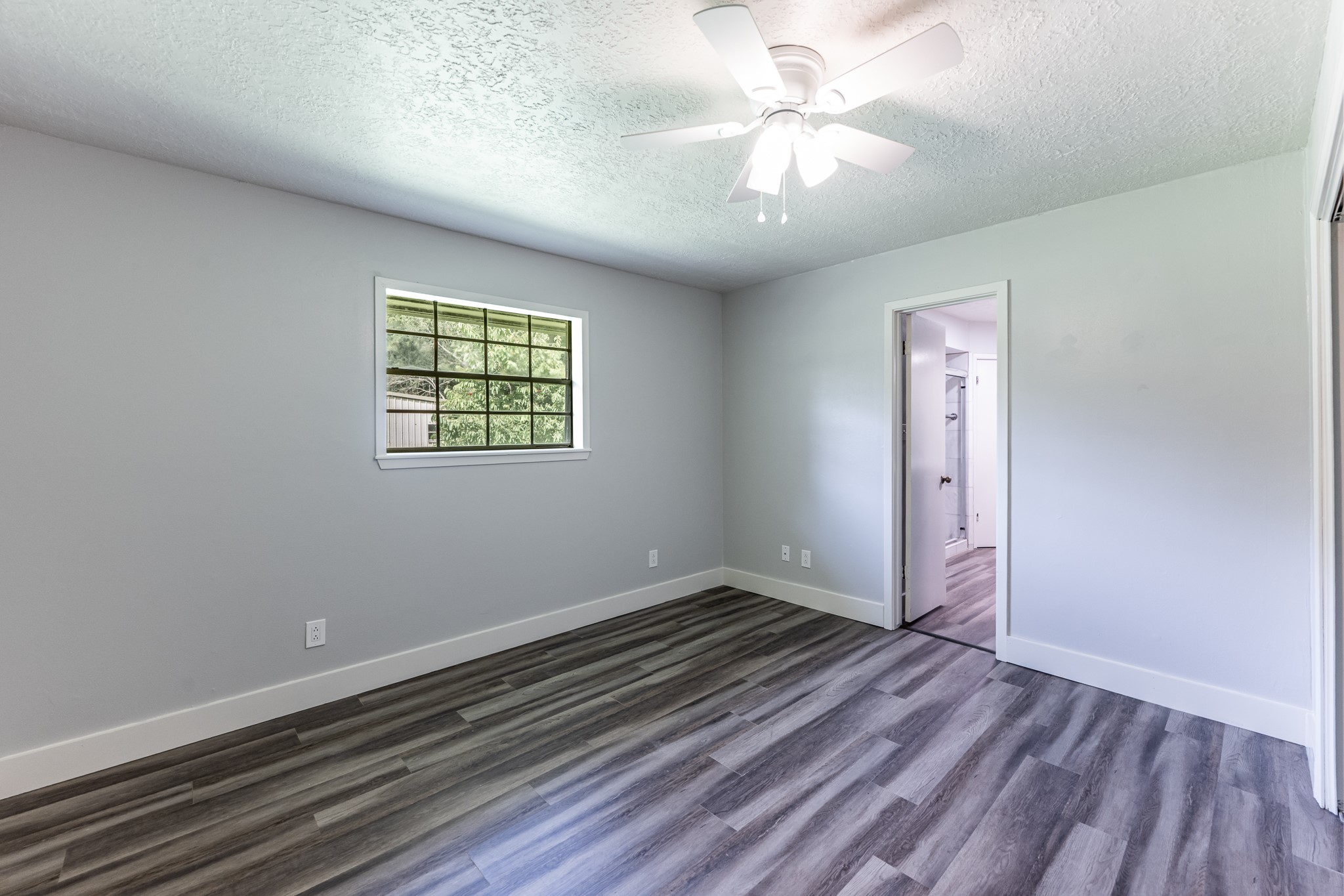 92 Mt Zion Road New Waverly, TX 77358 - Photo 11 of 33 wooden floor in an empty room with a window